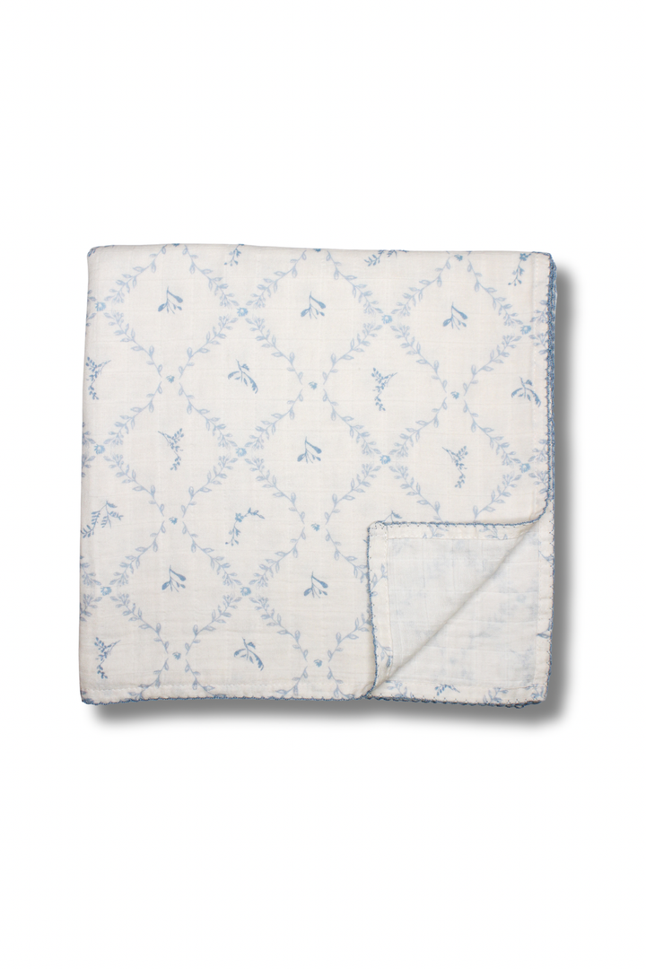 Blue lattice muslin blanket from Little Threads folded neatly with corner flipped up