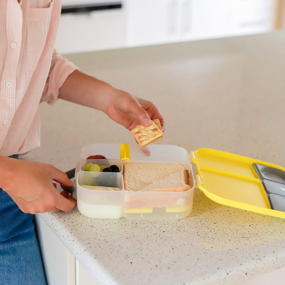 child eating from lemon sherbet mini bento box