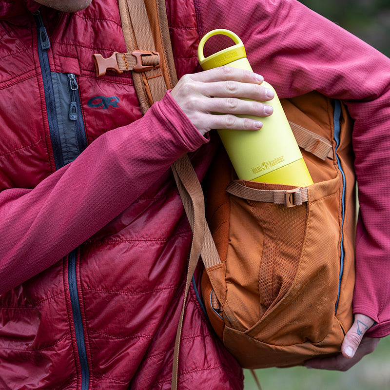 Backpack shot featuring Klean Kanteen 20oz Rise Classic Acacia Bottle, crafted from natural materials and leak proof.