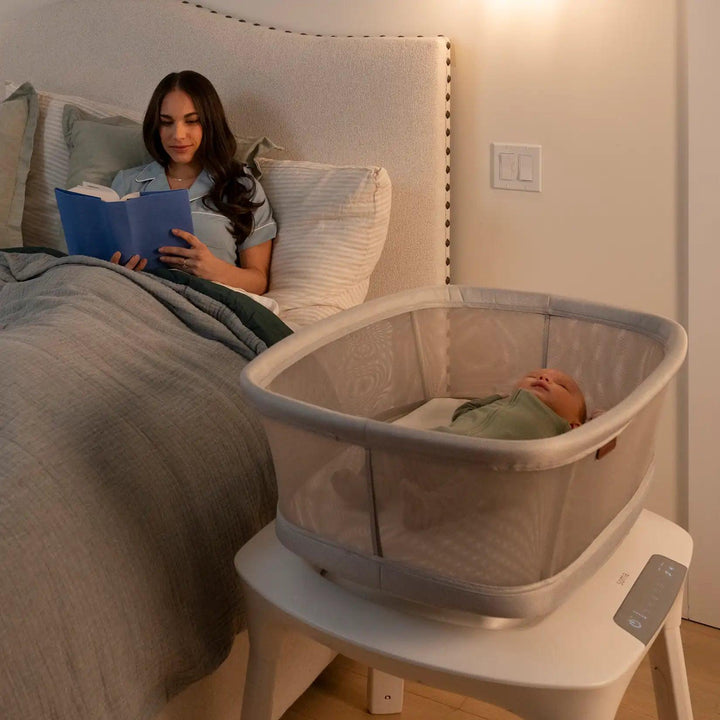 woman and baby in bedroom with soma smart bassinet by Uppababy