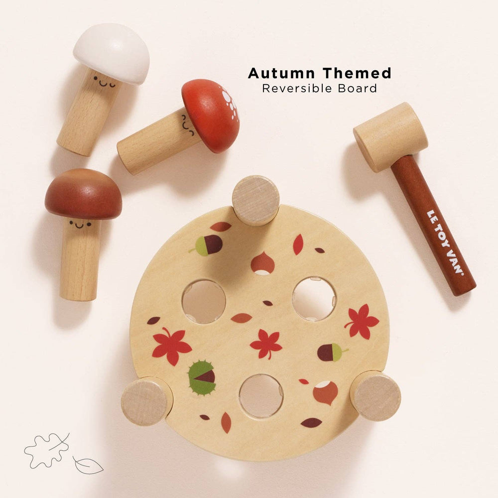 A reversible autumn leaf patterned board pairs with the mushrooms and hammer from Le Toy Van's game