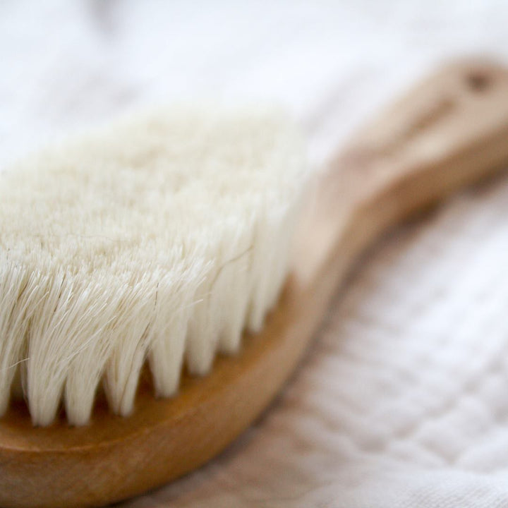 closeup picture of bristles on haakaa goat hair natural wood baby hair brush