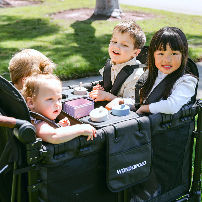 Featuring the Wonderfold Flex Snack Tray in use with a W4 wagon stroller, perfect for mess-free toddler meals outdoors.