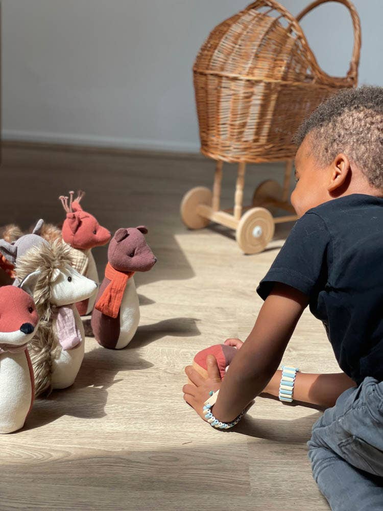 child playing with egmont toys forest friends soft toy animal bowling game