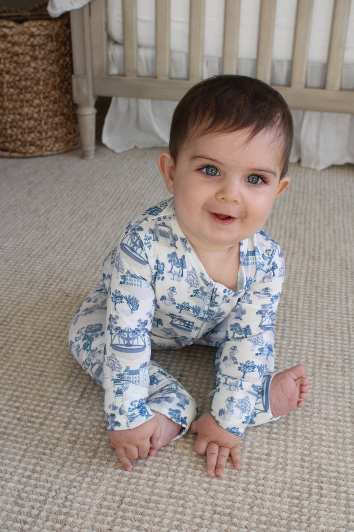Little Threads baby footie pajama worn while crawling on a soft neutral carpet