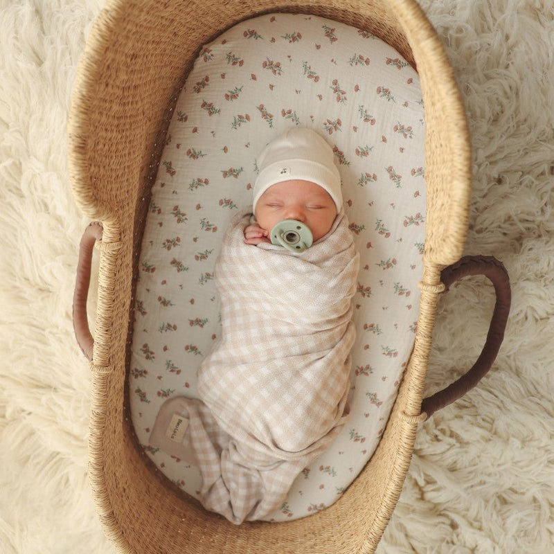 Newborn baby swaddled in a Bleu La La checkered knit blanket, breathable cotton for cozy everyday comfort