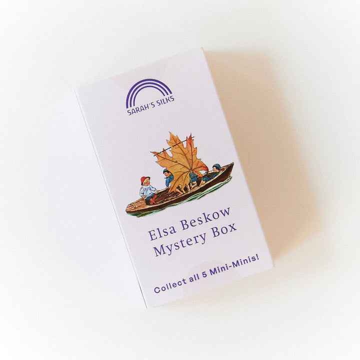 Standing upright, a single Elsa Beskow Mini Mystery Playsilk box displays its Sarah's Silks branding