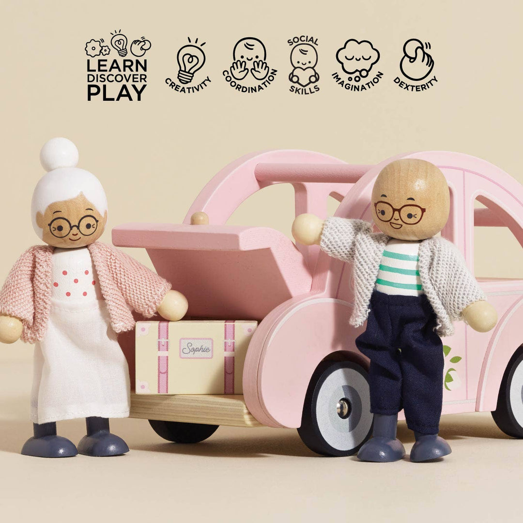 Two wooden dolls standing beside Sophie's Dolls House Toy Car by Le Toy Van, pretend play vehicle for doll families