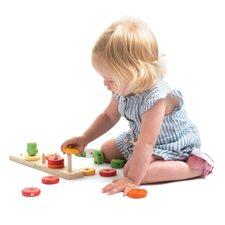 The Tenderleaf Toys Counting Carrots, a wood toy, inspires imaginative play while teaching numbers.