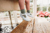  Little Love Bug Co. white leather t-bar shoes with anti-slip soles.