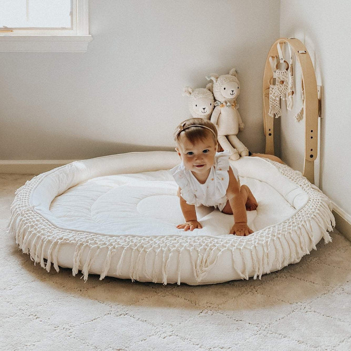 Create a cozy play space with the Finn + Emma Organic Round Play Mat, a beautifully crafted organic play mat baby will love.