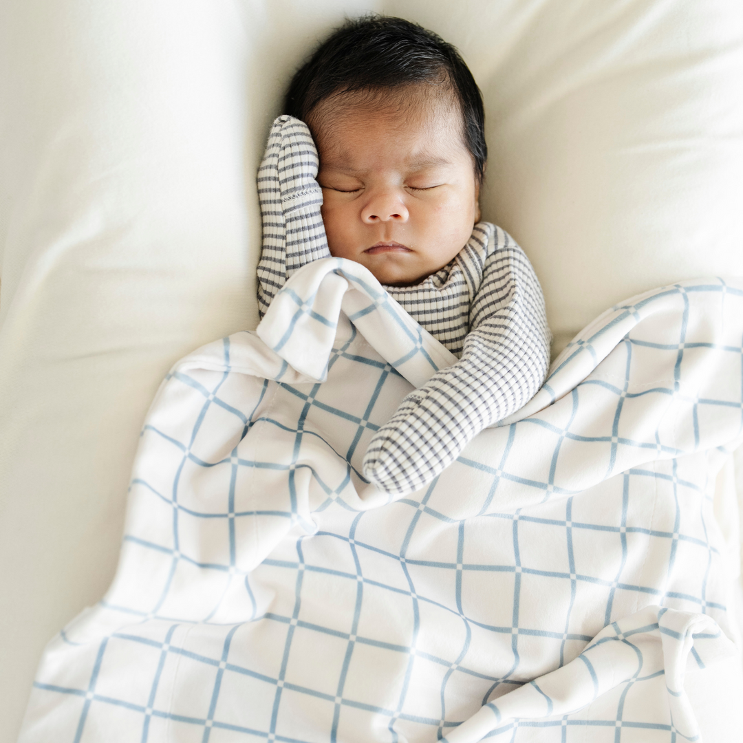The Saranoni Minky Stretch Receiving Blanket in Grid brings soothing comfort for baby boy blankets and everyday snuggles.