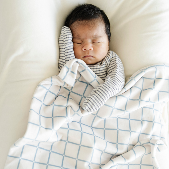 The Saranoni Minky Stretch Receiving Blanket in Grid brings soothing comfort for baby boy blankets and everyday snuggles.