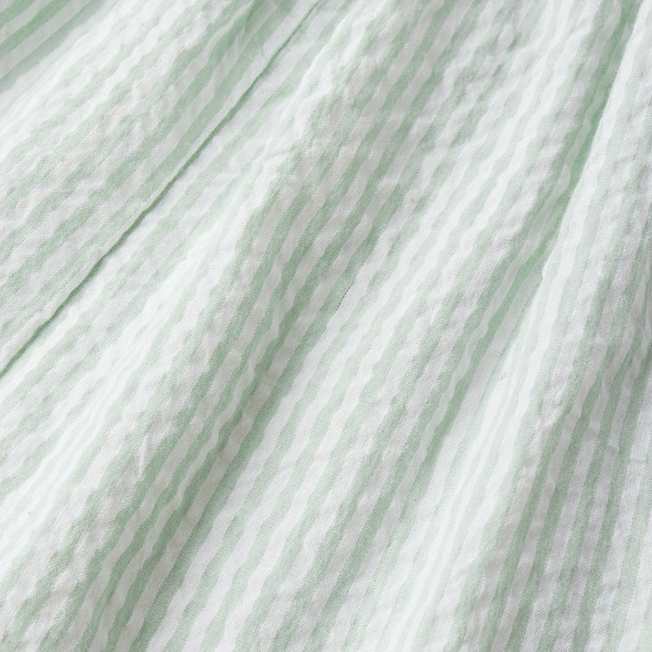 Organic seersucker bubble romper in basil stripe lifestyle shot - MakeMake Organics infant outfit