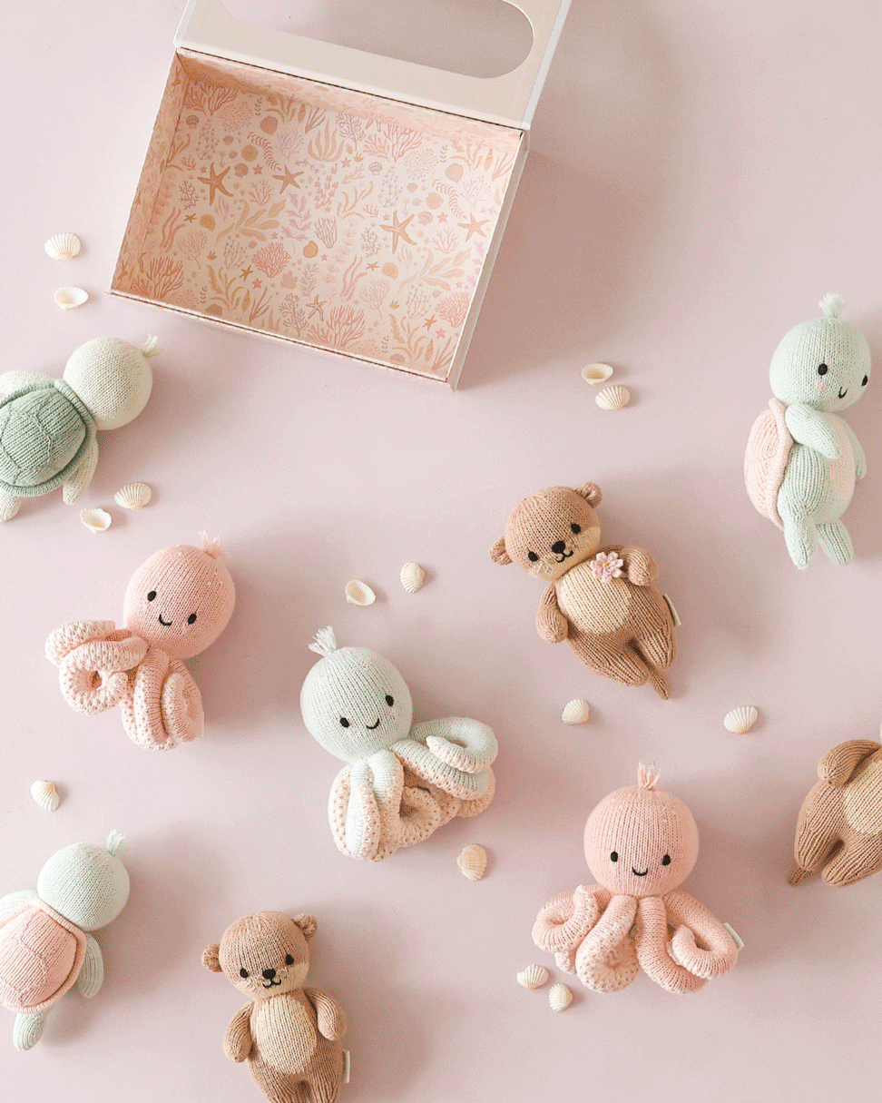 Heirloom octopus stuffed animal by Cuddle + Kind: Baby Octopus in Soft Coral Pink, hand-knit for newborns and up