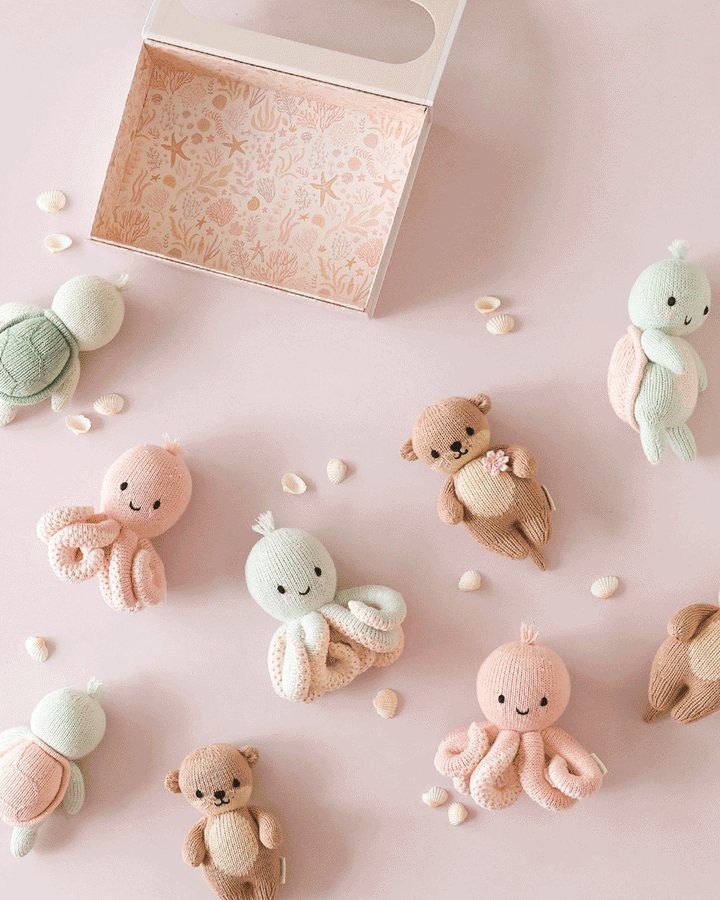 Heirloom octopus stuffed animal by Cuddle + Kind: Baby Octopus in Soft Coral Pink, hand-knit for newborns and up