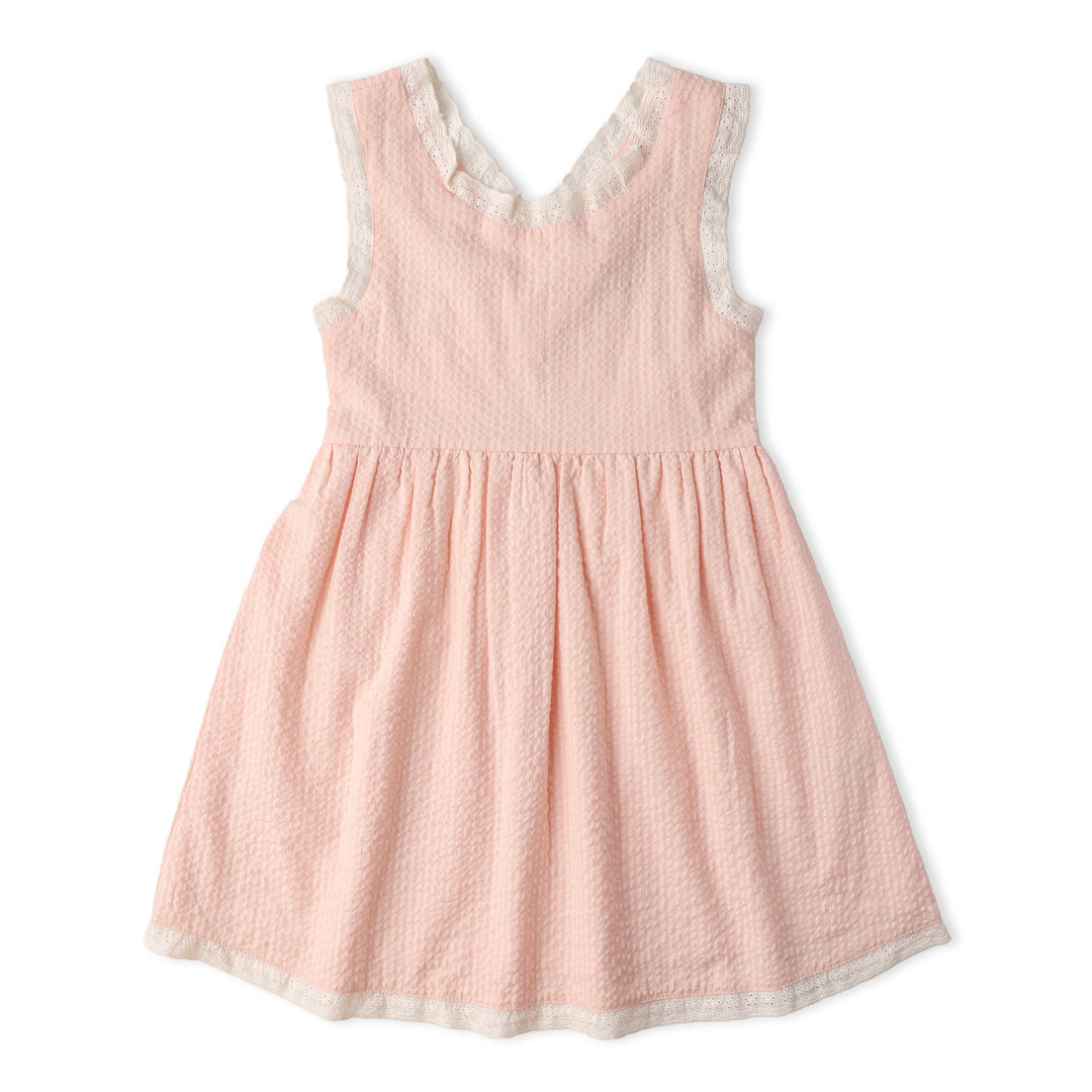 Baby wearing MakeMake Organics Blush Cross Back Dress - GOTS certified seersucker infant dress