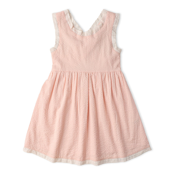 Baby wearing MakeMake Organics Blush Cross Back Dress - GOTS certified seersucker infant dress