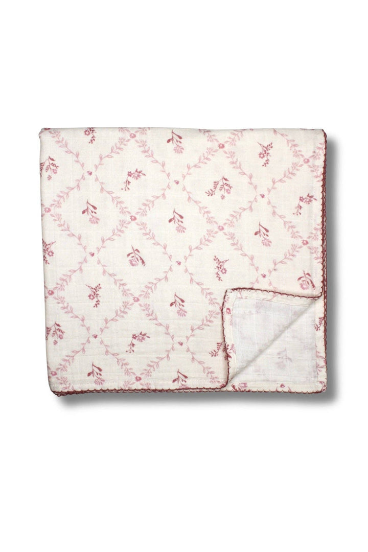 Mauve lattice muslin blanket from Little Threads folded with corner flipped to show soft backing
