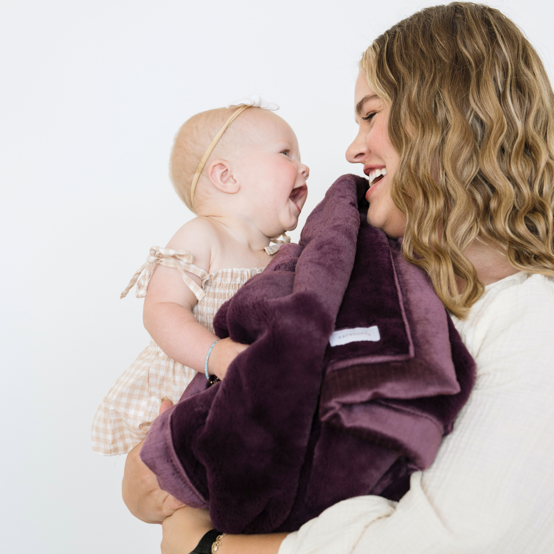 The Aubergine Saranoni Lush Receiving Blanket provides warmth and softness as a soft baby blankets option.