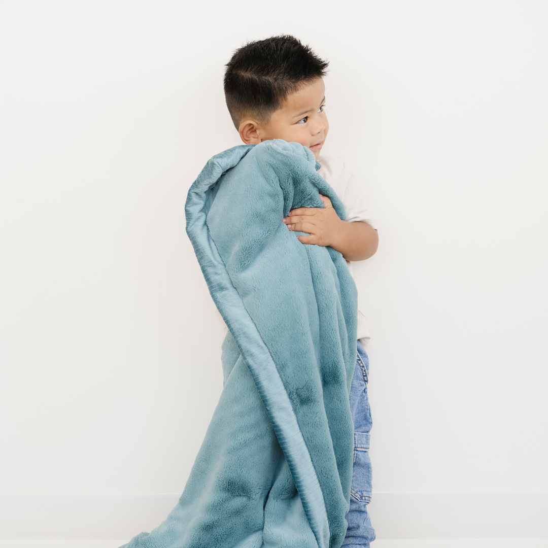 Keep toddlers warm with the Saranoni Lush Toddler Blanket in Mineral Blue, an ideal soft baby blankets choice.