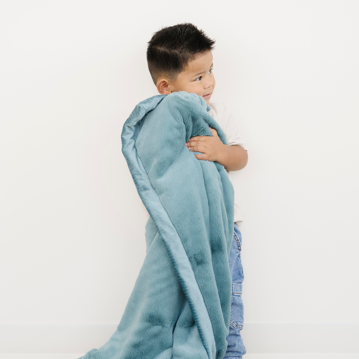 Keep toddlers warm with the Saranoni Lush Toddler Blanket in Mineral Blue, an ideal soft baby blankets choice.