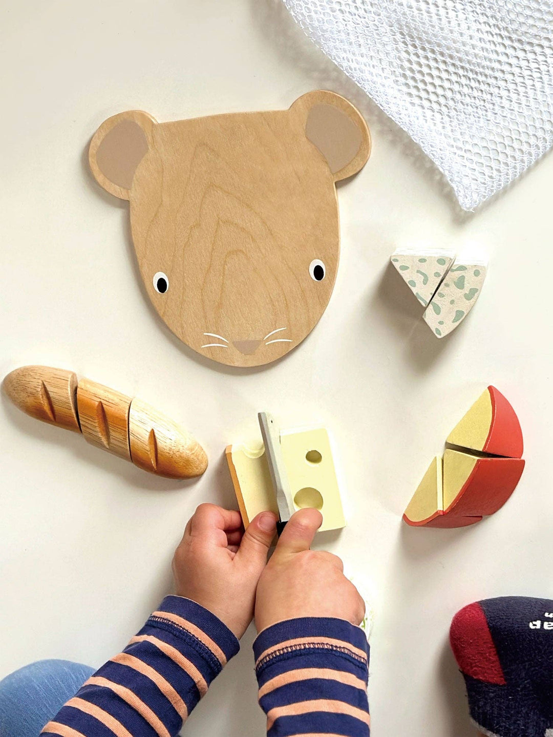 The Tenderleaf Toys Cheese Chopping Board, a Montessori-inspired toy, sparks creativity and motor growth.