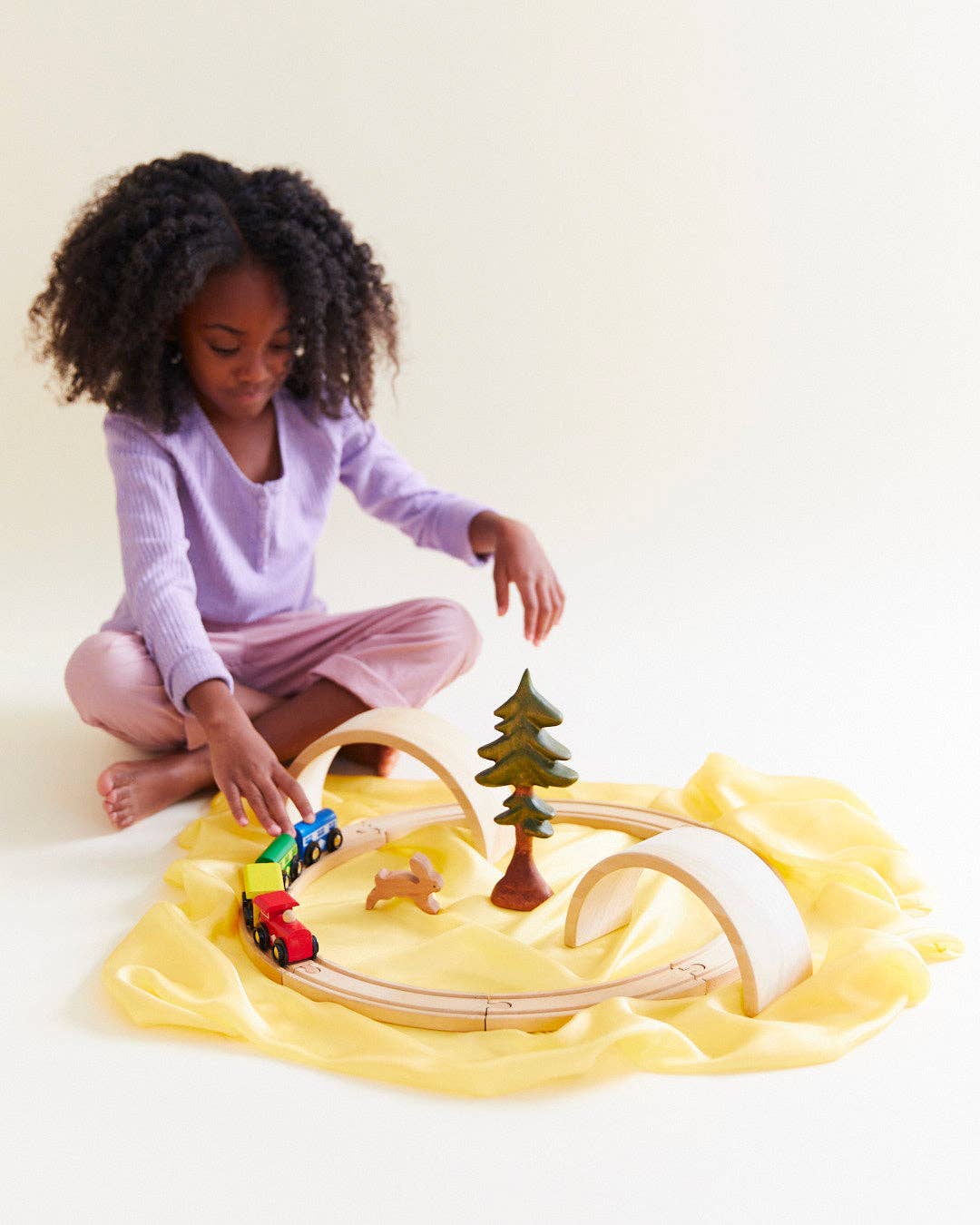 Yellow Sarah's Silks Solid Color Playsilk arranged in an imaginative play scene, a beloved silk toy