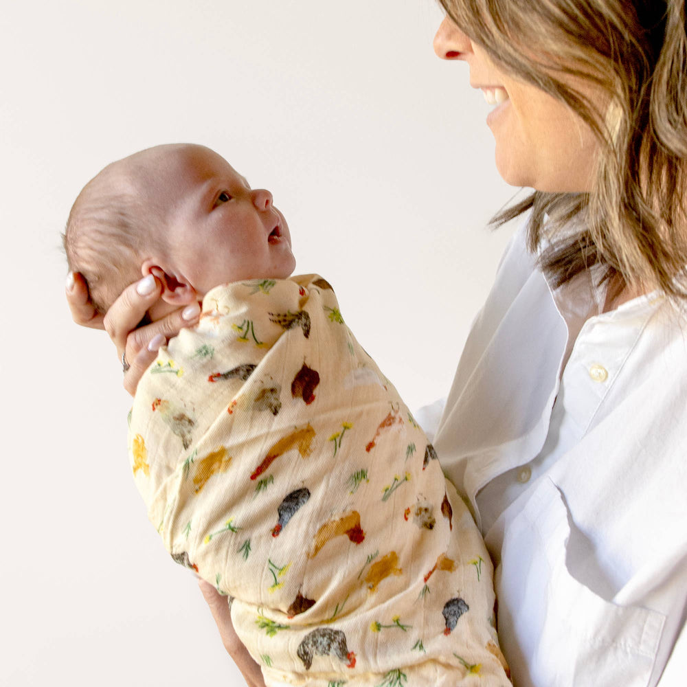 1canoe2 Chicken Meadows baby swaddle wrapped snugly around infant, farmhouse print muslin swaddle blanket