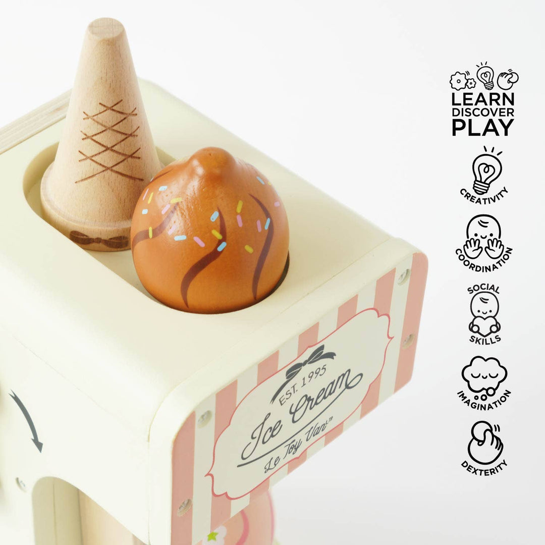 A pink swirl and a chocolate swirl cone sit tucked into the holder of Le Toy Van's Ice Cream Machine