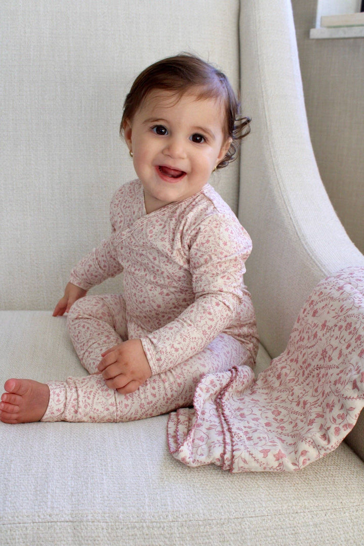 Baby sitting with Little Threads mauve heirloom vine muslin blanket, lightweight swaddle blanket for comfort, stroller use, and everyday care