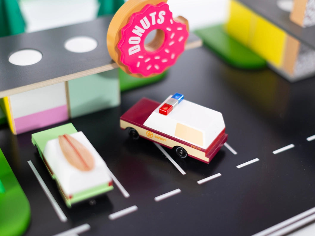 A Candylab Toys wooden Sheriff Truck, designed for kids to enjoy role-playing as law enforcement drivers.