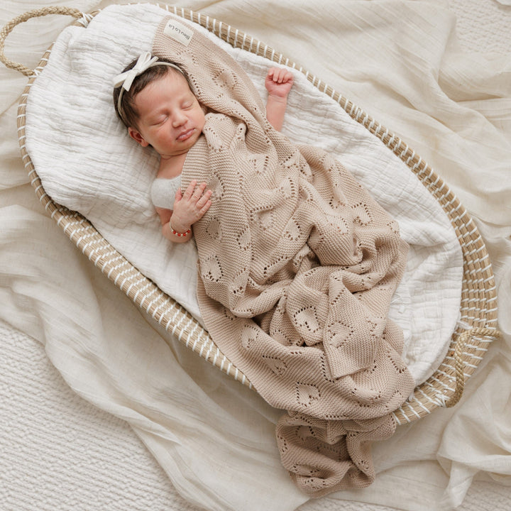 Newborn swaddled in Bleu La La 100% Cotton Luxury Knit Heart Swaddle Baby Blanket in oatmeal for soft, chemical-free comfort.