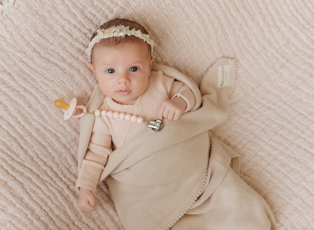 Baby resting in a neutral Bleu La La organic cotton luxe blanket, soft breathable cotton for everyday comfort