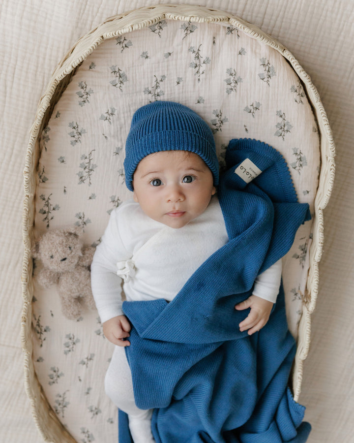Baby in a Bleu La La navy organic knit blanket with matching hat, luxe newborn set