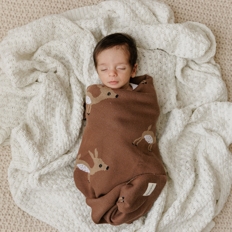 Newborn baby swaddled in a Bleu La La deer knit blanket, lightweight breathable cotton for cozy everyday comfort