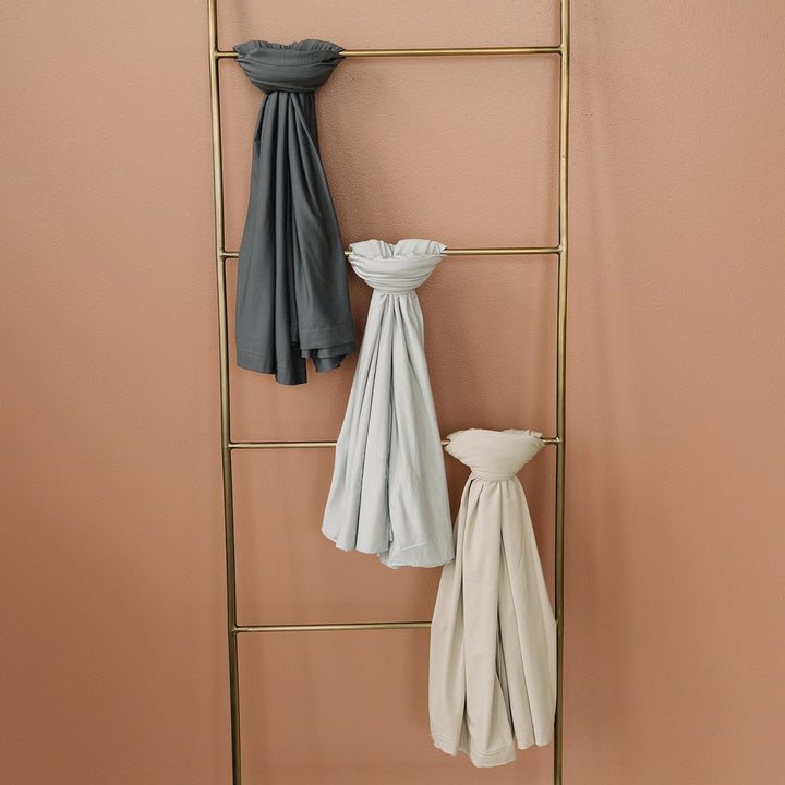 Mebie Baby Oatmeal Bamboo Stretch Swaddle held up to show the soft stretch fabric.