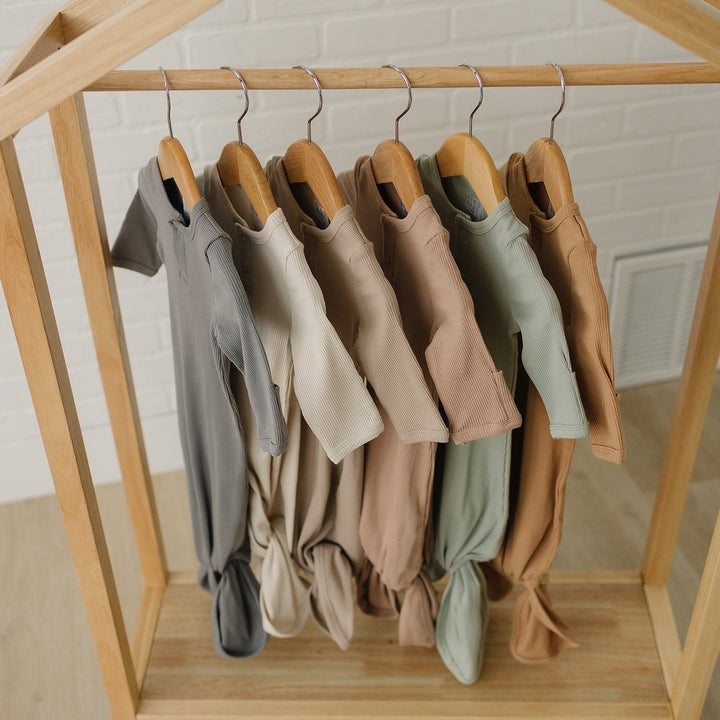 Shop newborn knot gowns at Mebie Baby, the Sage Organic Cotton Ribbed Knot Gown draped over a wooden hanger.