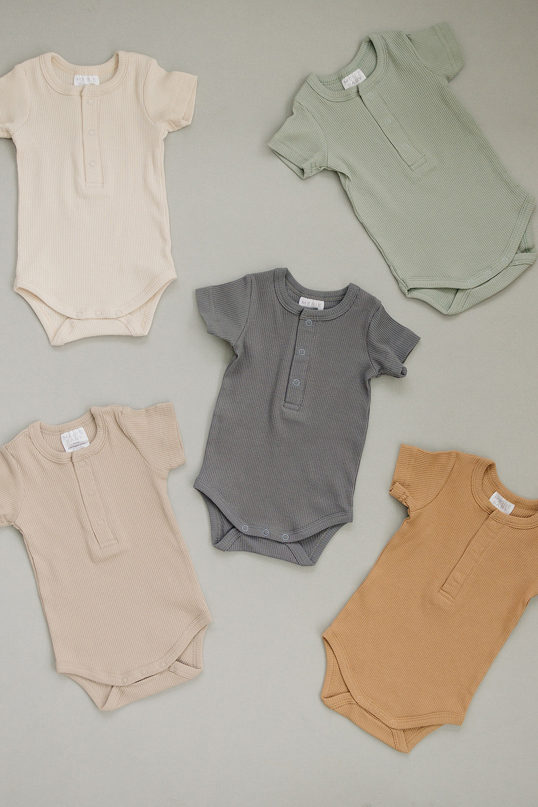 Organic cotton ribbed baby bodysuit, the Vanilla Organic Cotton Ribbed Snap Bodysuit styled with matching baby leggings.