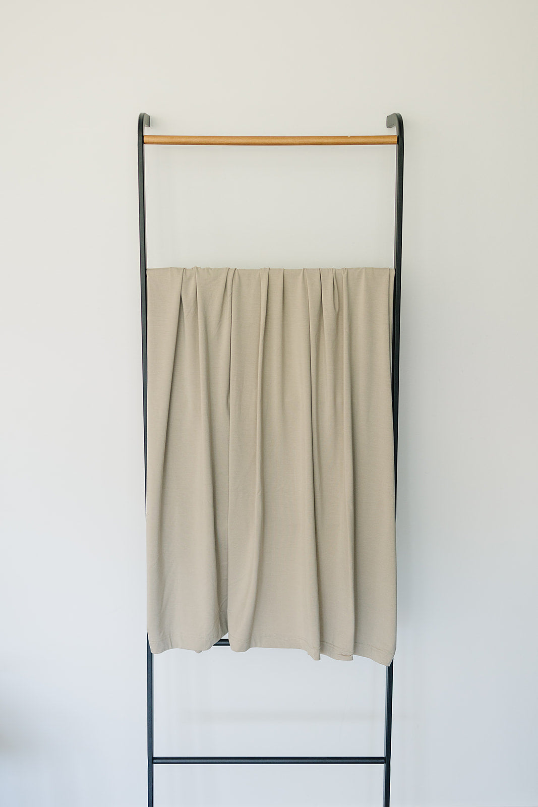 Shop swaddle blankets at Mebie Baby now, the Oatmeal Bamboo Stretch Swaddle styled with matching nursery decor.