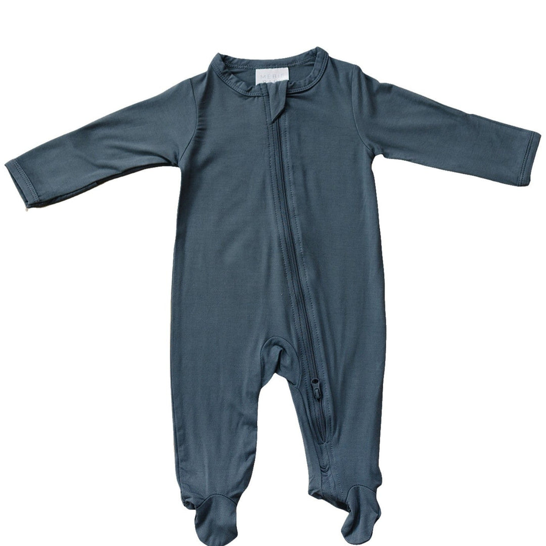 Charcoal Bamboo Footed Zipper by Mebie Baby, worn by a baby on a play mat.
