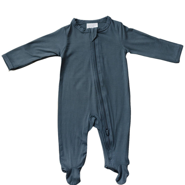 Charcoal Bamboo Footed Zipper by Mebie Baby, worn by a baby on a play mat.