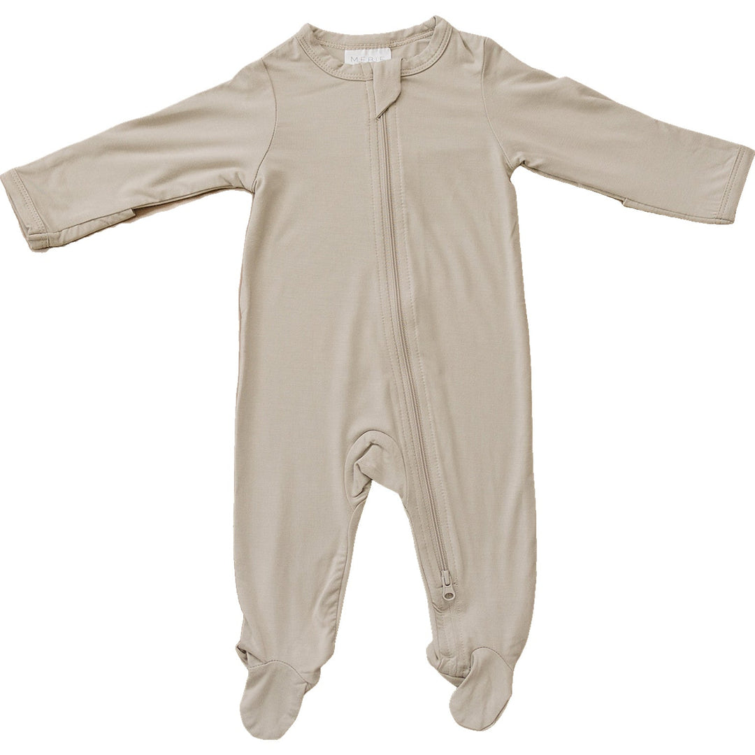 Oatmeal Bamboo Footed Zipper by Mebie Baby, worn by a baby on a play mat.