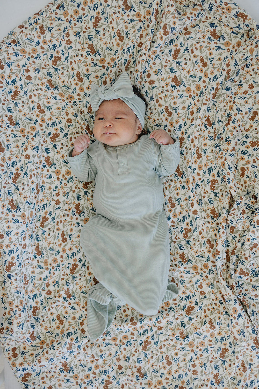 Laid flat to show the ribbed knit fabric, the Sage Organic Cotton Ribbed Knot Gown from Mebie Baby.