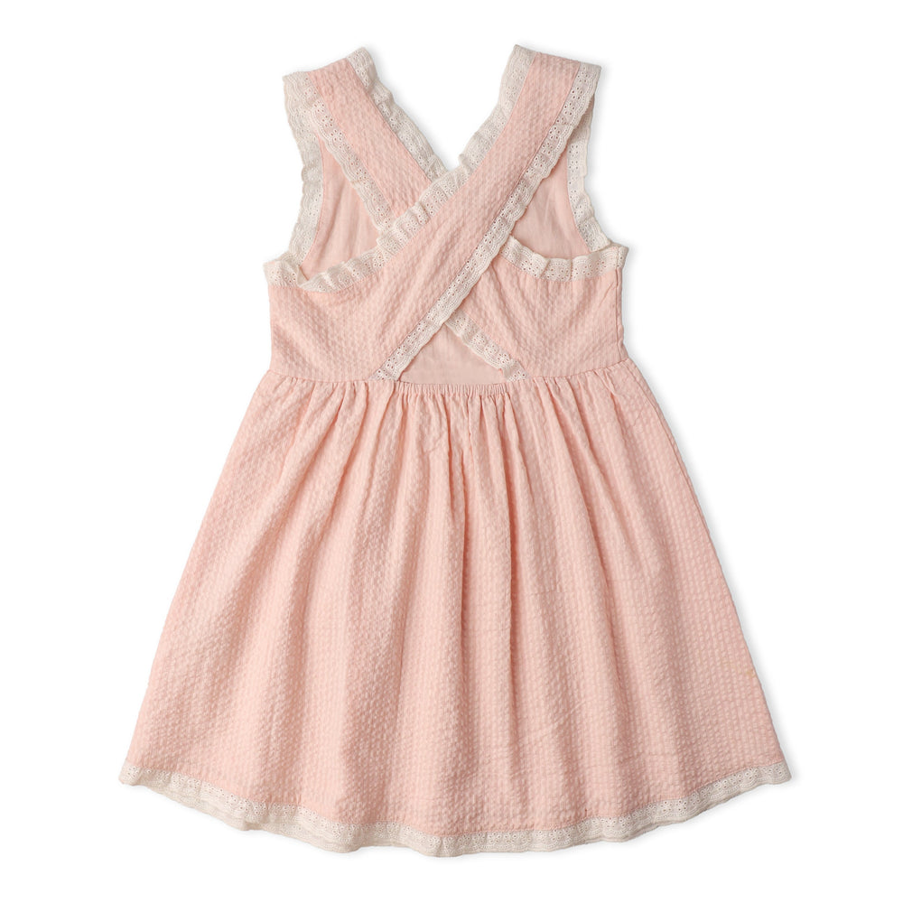 Blush organic cross back dress lifestyle shot - MakeMake Organics feminine organic baby dress