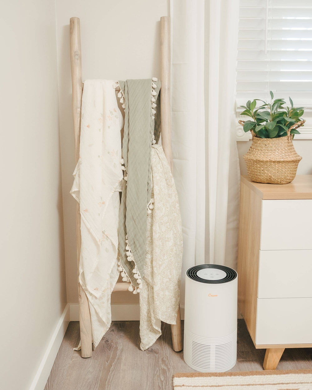 three soft green sage and neutral baby swaddles in crane baby modern nursery 