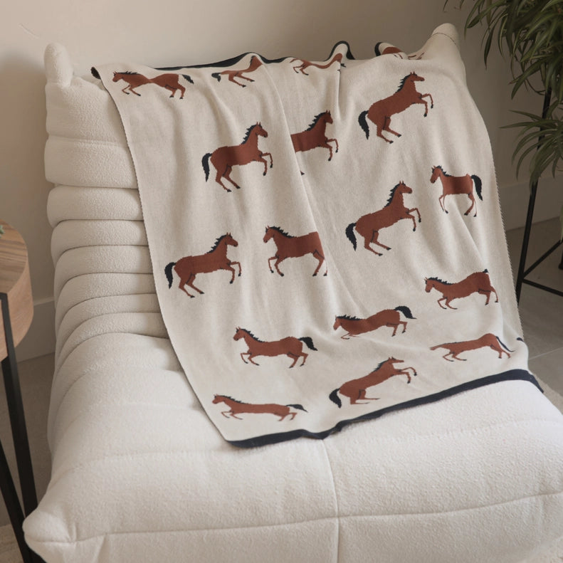 Keep baby cozy with this Horse Viverano Organics knit baby blanket made from soft organic cotton.