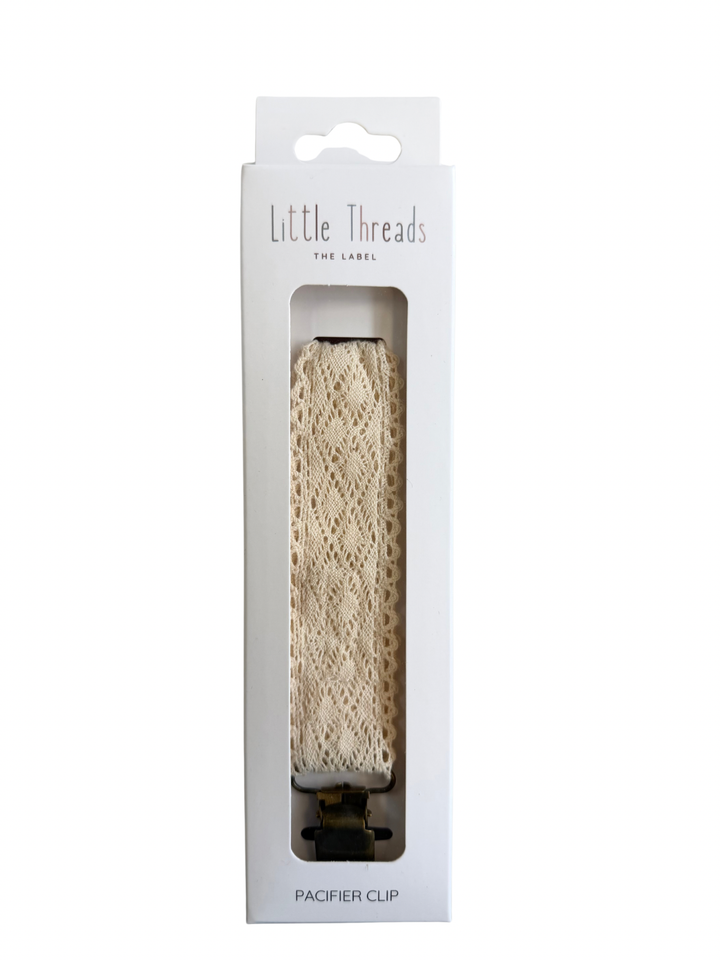 Neutral crochet paci clip in its Little Threads box, the Diamond Crochet Collection Pacifier Clip
