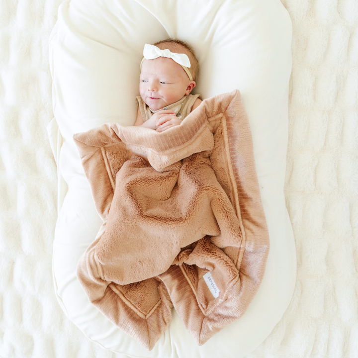 Parents gravitate toward Saranoni Lush Mini Blanket in Rosy for that plush hugging texture in the best baby blanket category.