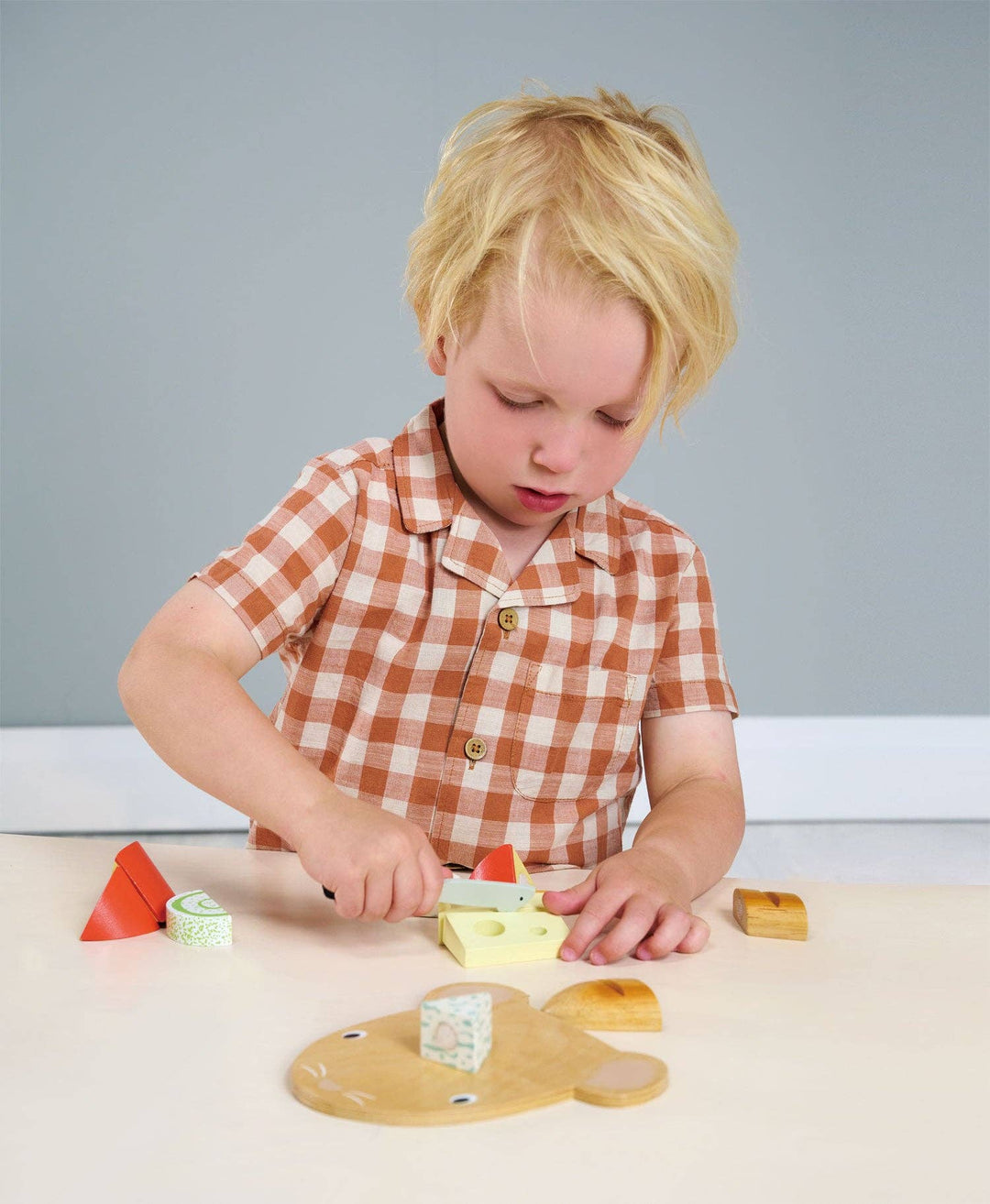 Children enjoy imaginative play with the Tenderleaf Toys Cheese Chopping Board, a kid-friendly wood toy.